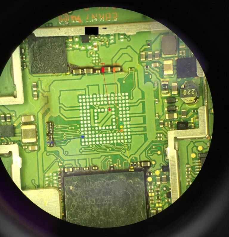 A close up of a circuit board through a magnifying glass.