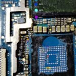 A close up of a chip on a motherboard.